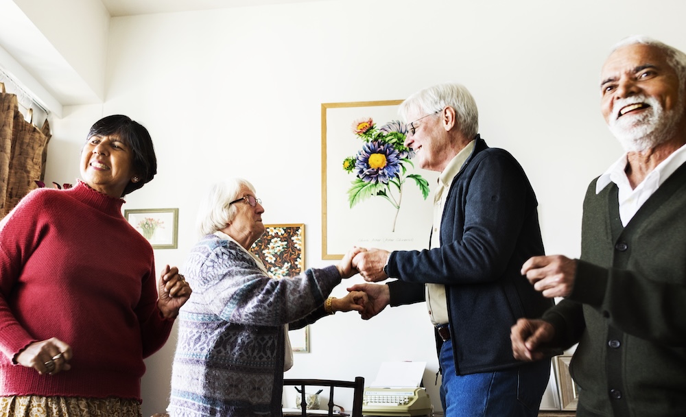 Group of seniors friends dancing together at their senior living communities dearborn mi